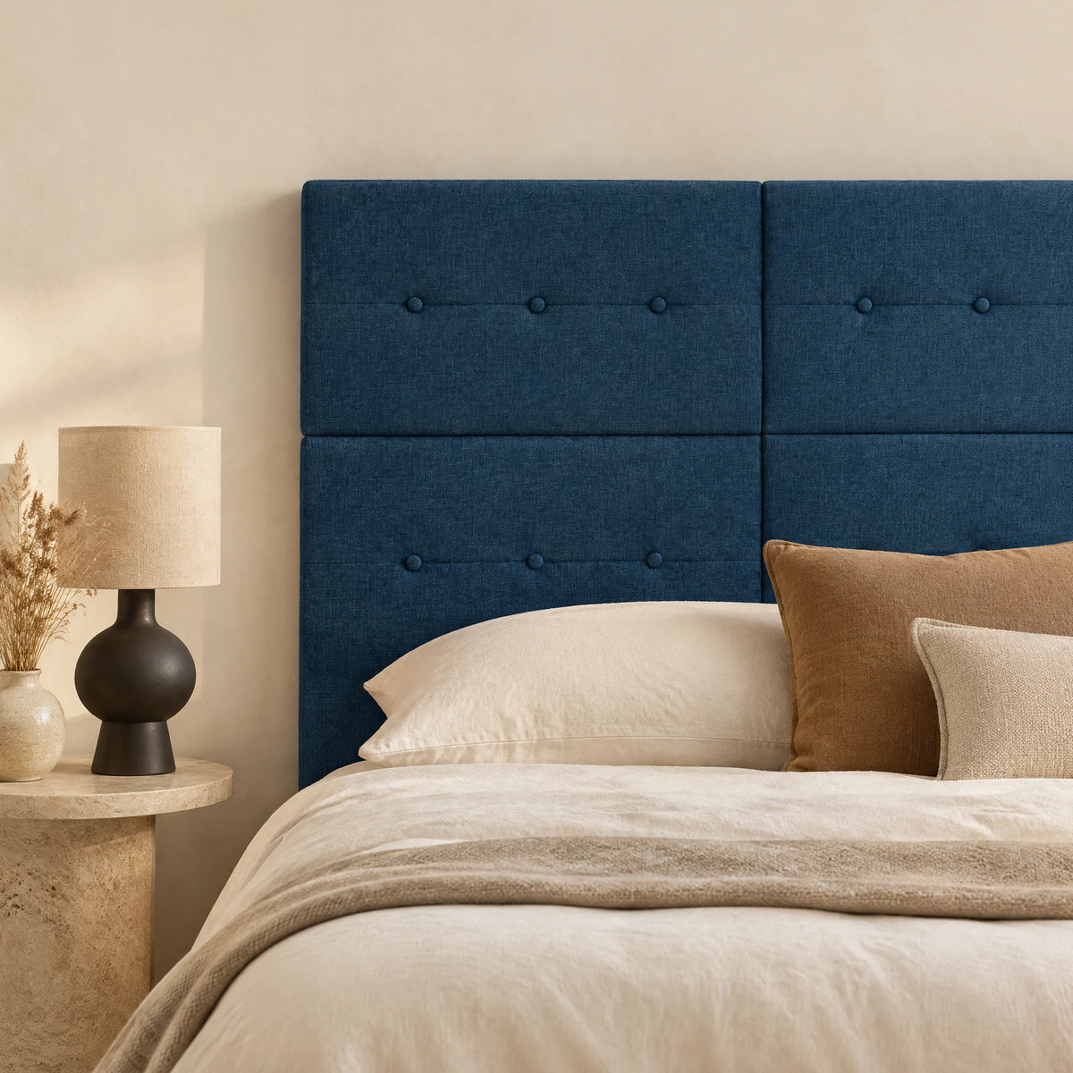 Tête de lit haute en tissu Bastille bleu nuit dans une chambre, avec table de chevet et lampe