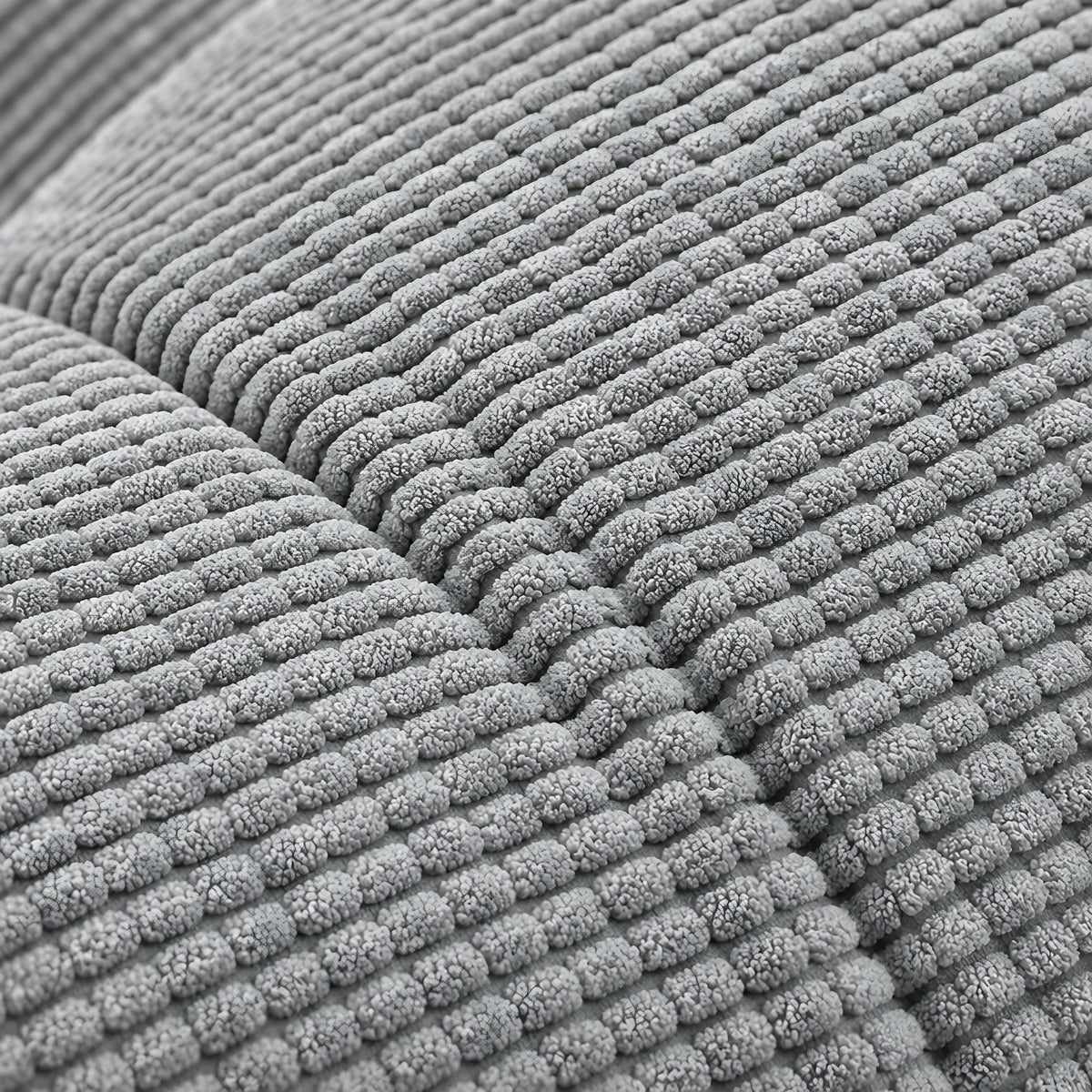 Gros plan du velours côtelé et du capitonnage du coussin Opéra